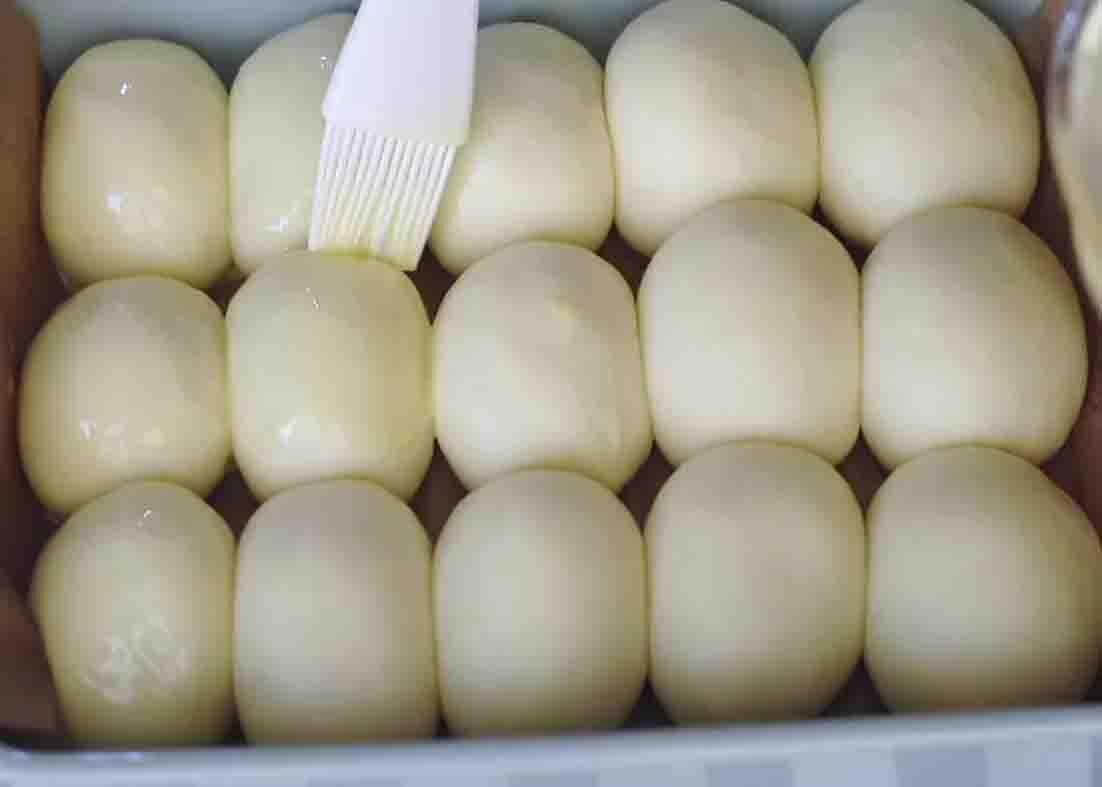 Brushing the dinner rolls with some eggwash