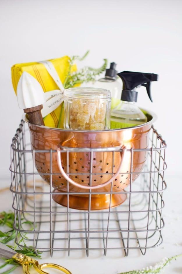 Gift basket arranged inside a colander for a clever kitchen themed present for a budget friendly upgrade