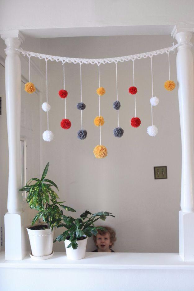 DIY Pom Pom Garland, a fun way to try a new fiber craft and a pretty accent piece made entirely from yarn