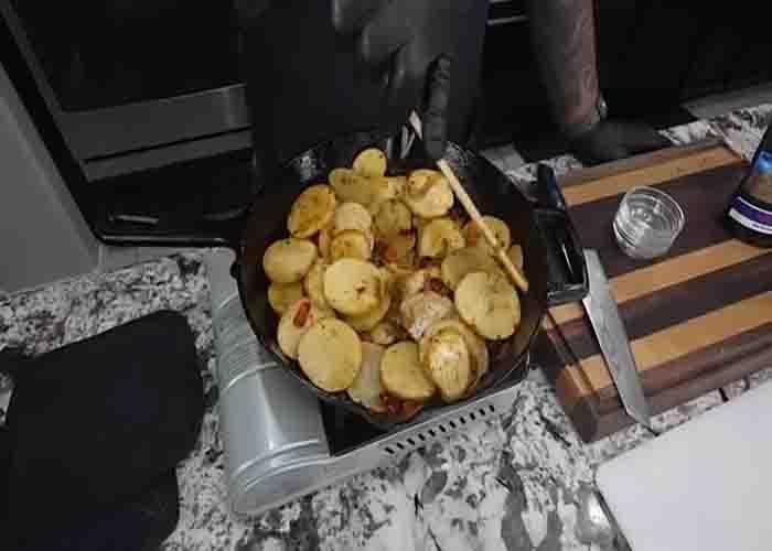 Cooking the Southern skillet potatoes and onions