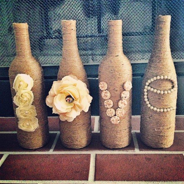 Twine wrapped wine bottles, four jute covered bottles spelling love with fabric roses, buttons and pearls