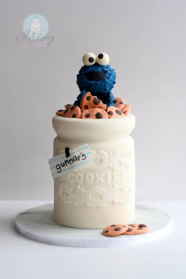 Cake carved and decorated to look like a ceramic cookie jar with a blue Cookie Monster figure on top