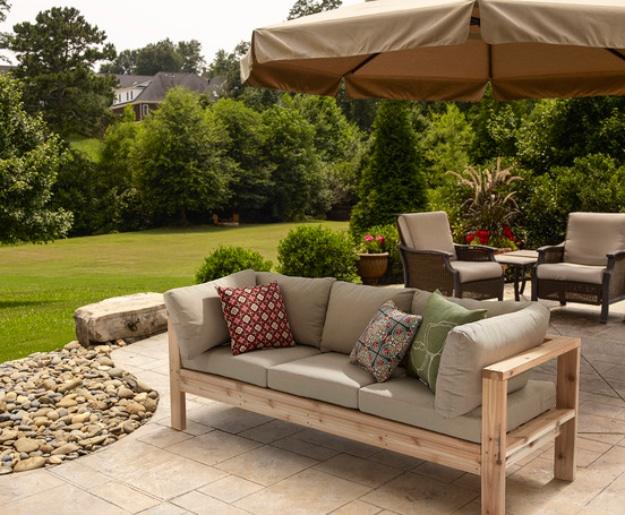 Cedar toned 2x4 outdoor sectional sofa with taupe cushions and patterned pillows on a stone patio under an umbrella
