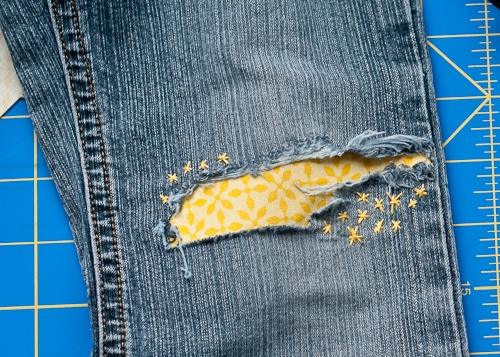 Mend Torn Jeans, one of the best clothes hacks on this list and an idea that is easy to recreate at home
