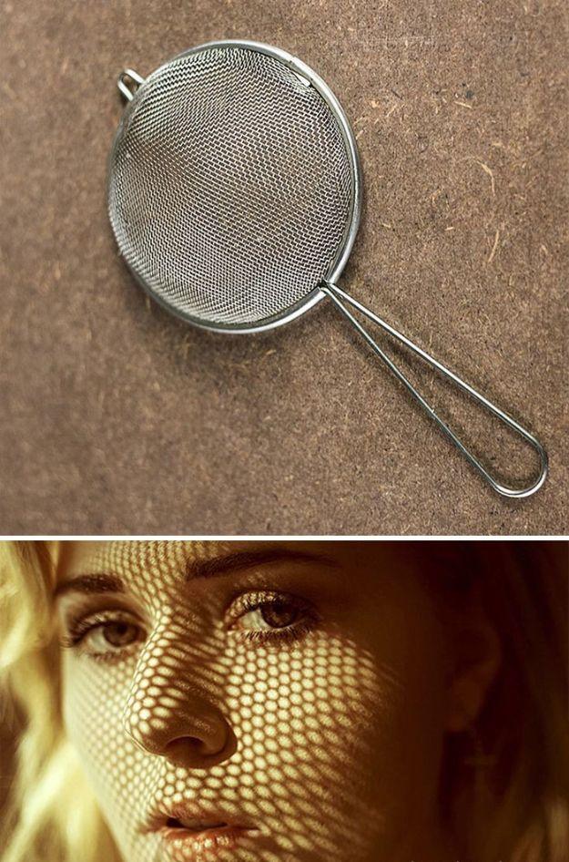 Sifter shadow hack, a metal mesh tea strainer above a portrait of a woman with a mesh shadow across her face