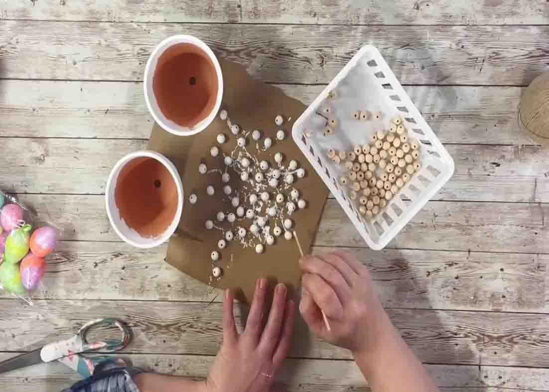 Painting the clay pots and beads with white chalk paint