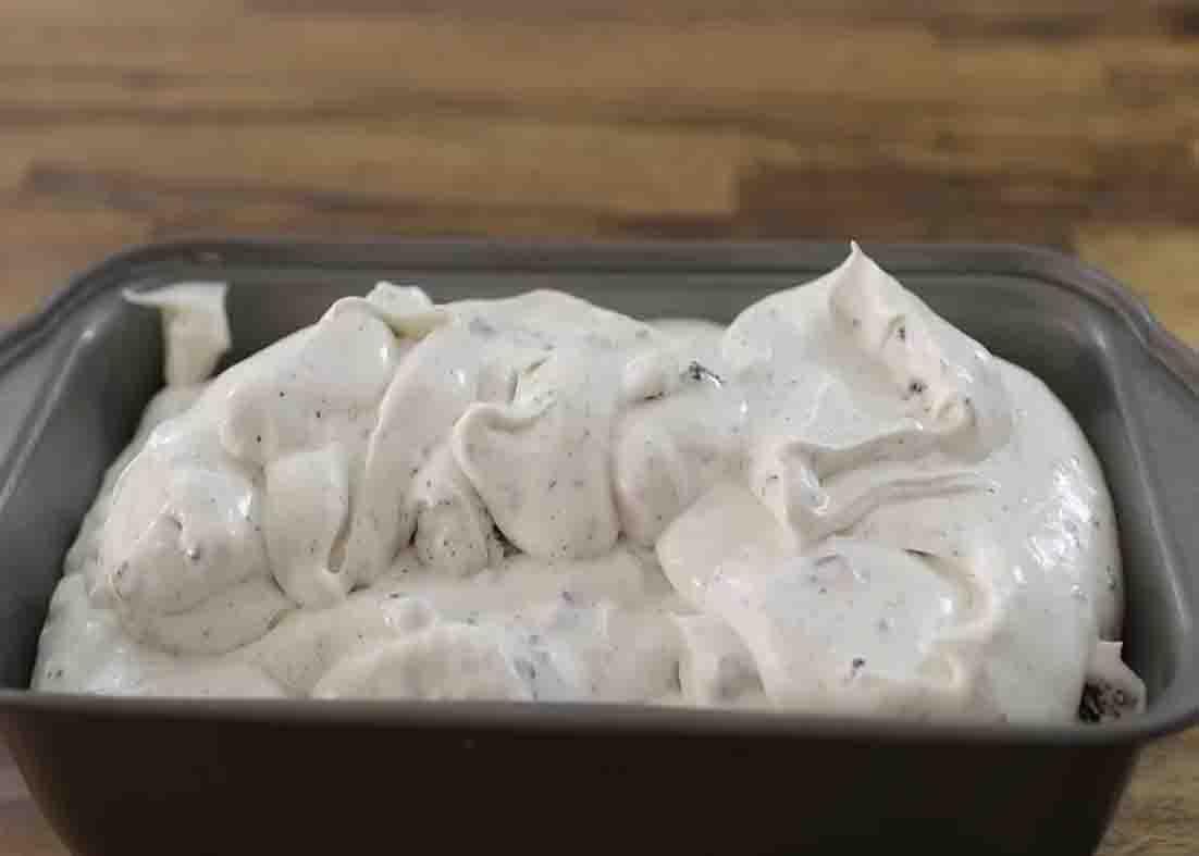 Transferring the oreo ice cream to the ice cream container