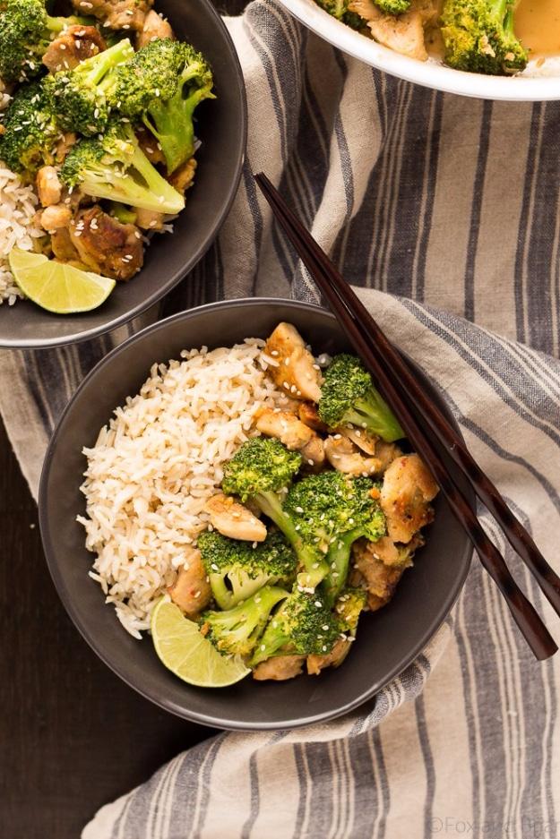 Peanut sauce chicken and broccoli bowl over rice with a creamy peanut sauce and sesame seeds for a twenty minute dinner