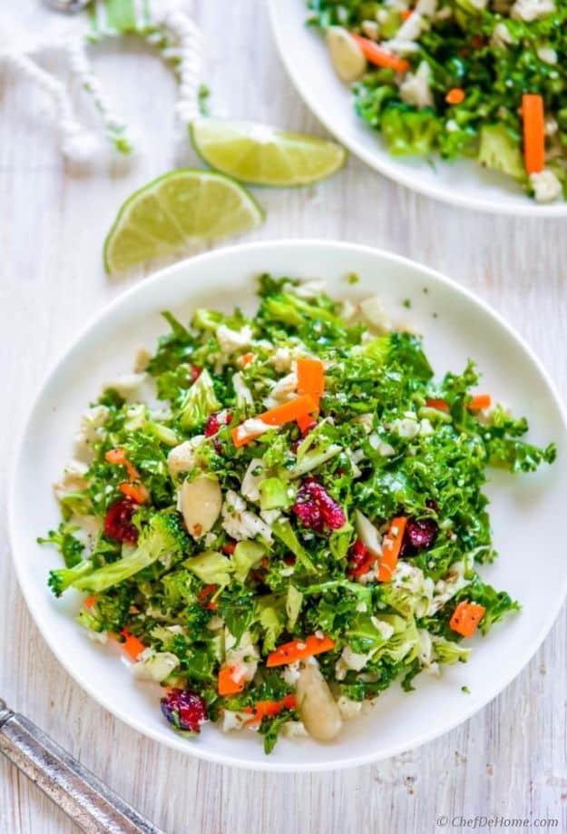 Cauliflower and broccoli detox salad, finely chopped green vegetables with shredded carrot and cranberries on a white plate