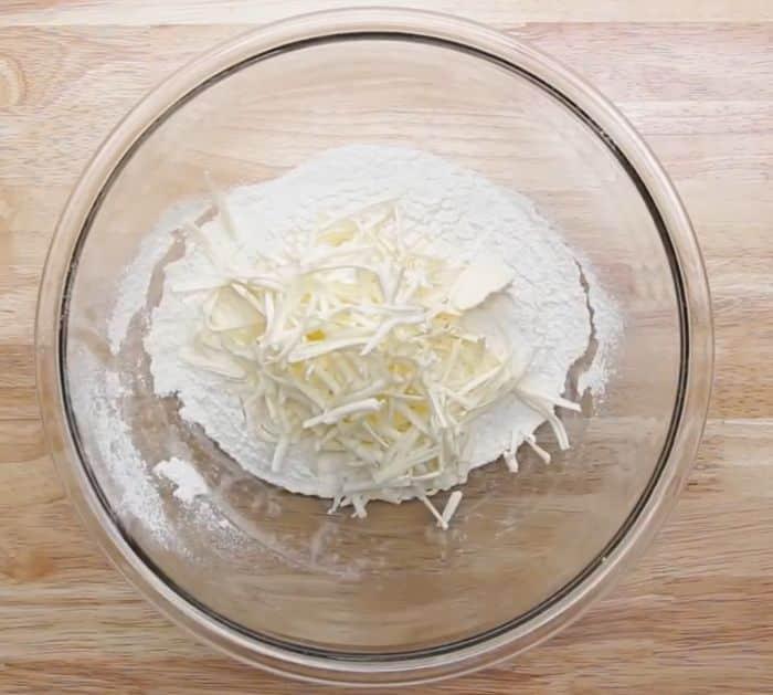 Cold butter shredded on a grater so it mixes into pastry dough easily, a Thanksgiving baking hack for pies