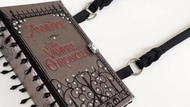 DIY book purse made from a dark hardcover with silver filigree corners and a black strap, shown closed
