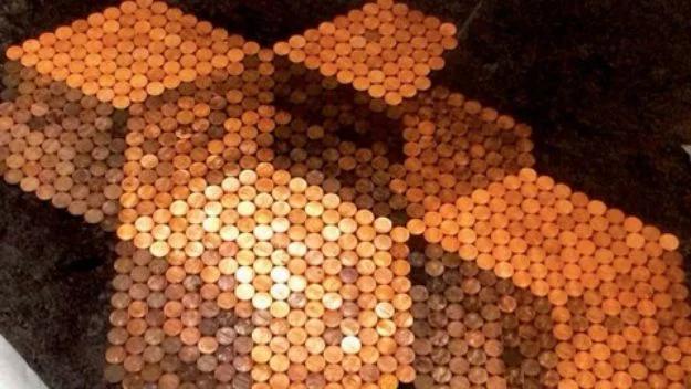 DIY penny flooring, hundreds of copper pennies laid in a pattern and sealed under clear glossy epoxy resin