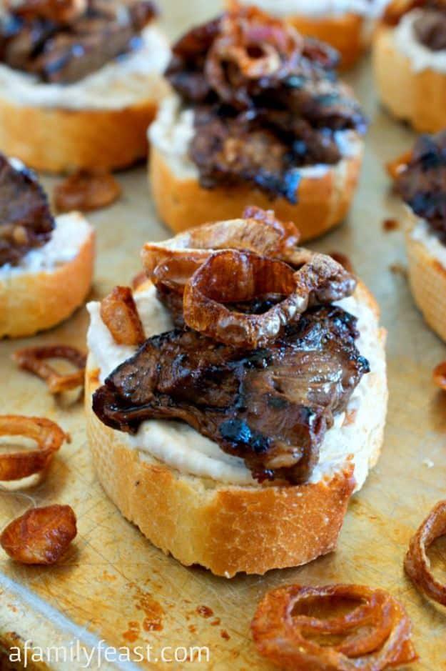 Beef crostini topped with creamy horseradish spread, sliced steak and crispy fried shallots on toasted bread
