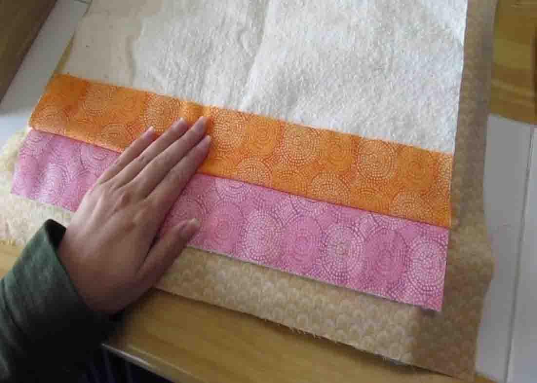 Layering the fabric strips for the large hot pad