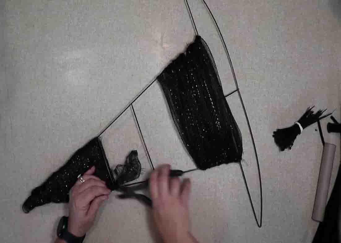 Wrapping the metal body with black mesh to make the witch hat