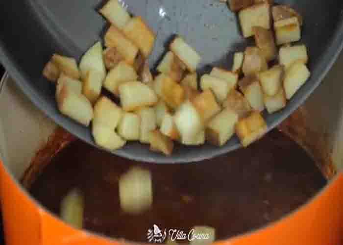 Stirring in the potatoes to the chile Colorado sauce
