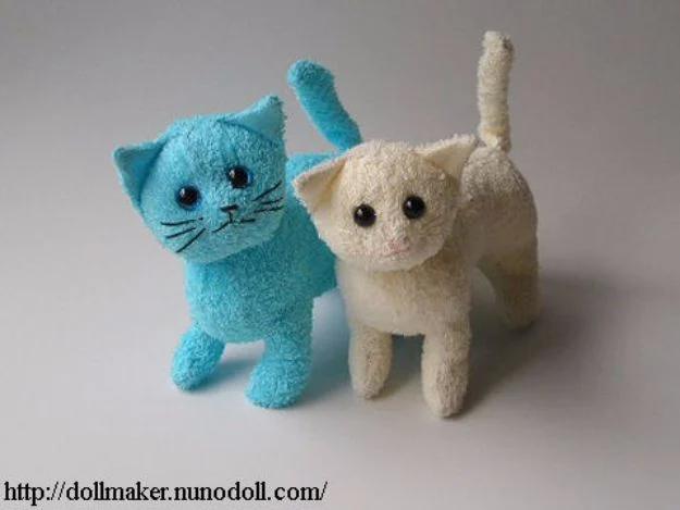 Terry cats, two soft toy cats sewn from turquoise and cream towel with black bead eyes, standing on all fours