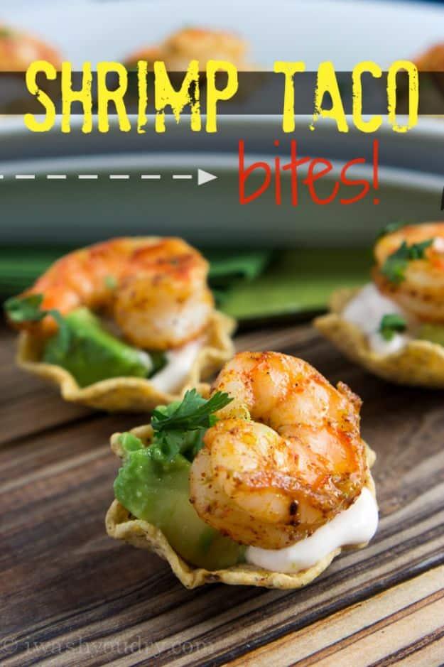 Shrimp taco bites built on tortilla chip scoops with diced avocado, chipotle sour cream and chili shrimp