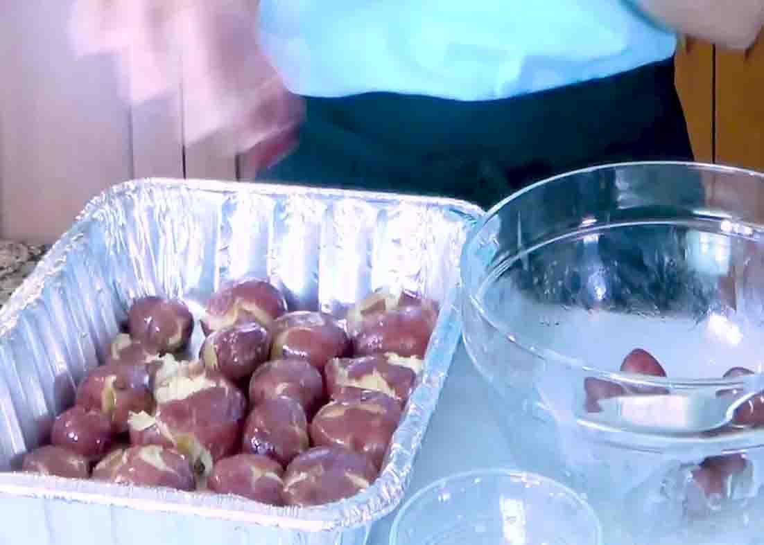 Mashing the potato and placing them on the bottom of the tray