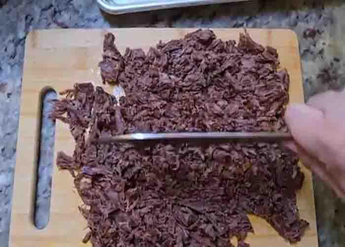 Chopping the meat for the birria sandwiches