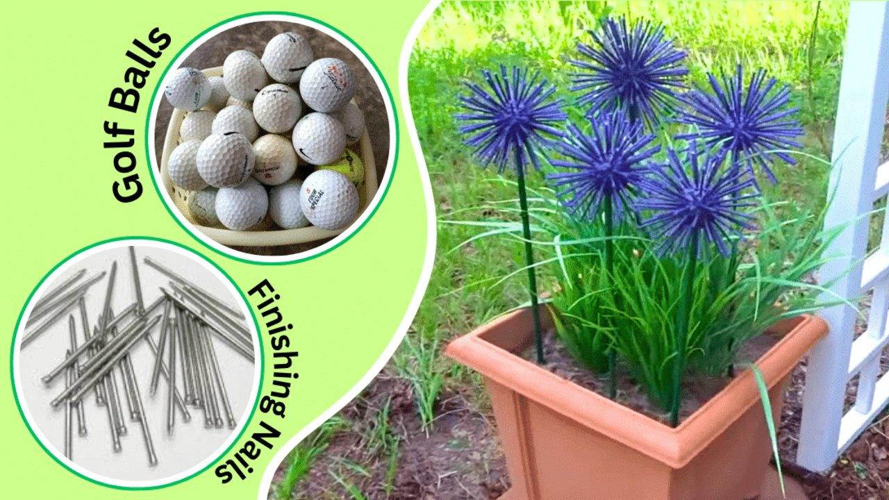 Purple faux allium flowers made from golf balls and nails on green stems, standing in a terracotta planter in a garden