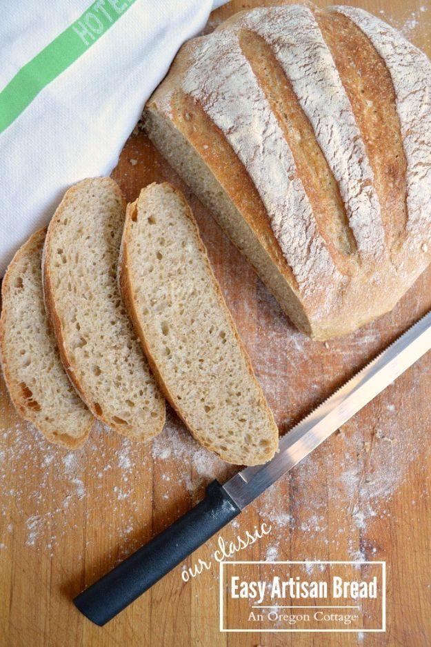 Round loaf of easy artisan bread with a deep golden crust, baked in a Dutch oven and cooling on a rack