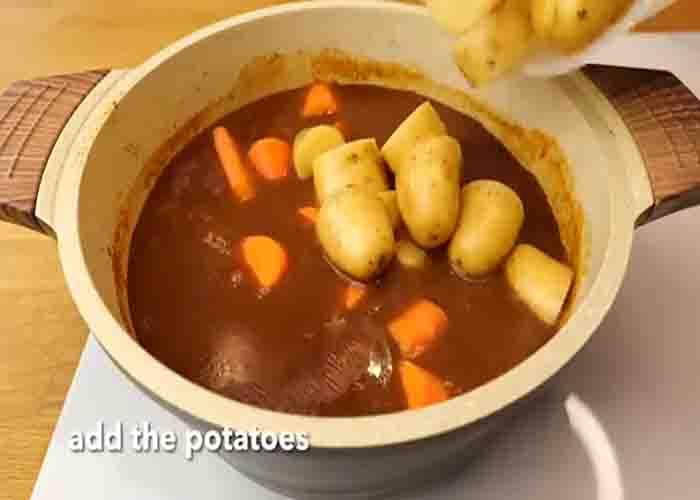 Adding the potatoes to the stew recipe