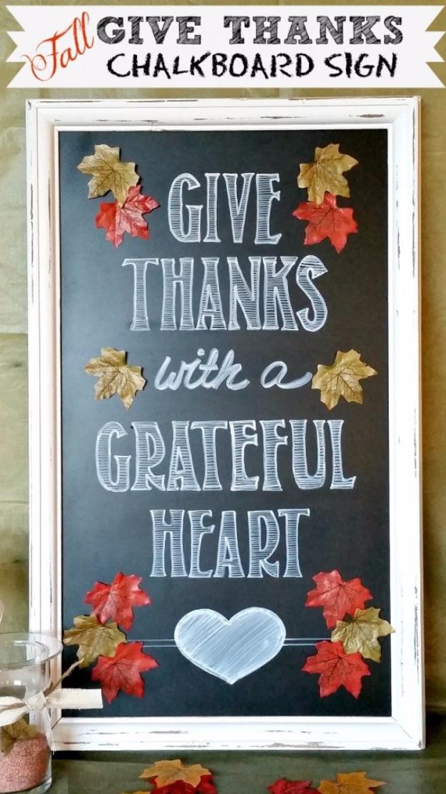 Give Thanks chalkboard sign made from a repurposed cabinet door framed with a rustic leaf and berry garland
