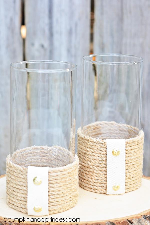 DIY rope lantern vases, two clear glass cylinders wrapped in sisal rope with white twill bands and gold studs