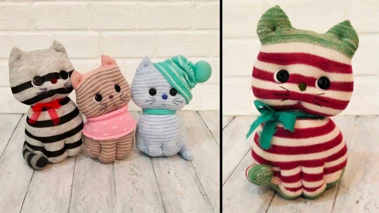 Stuffed kitten made from socks, four striped sock cats in red green and pink with stitched faces and knotted scarves