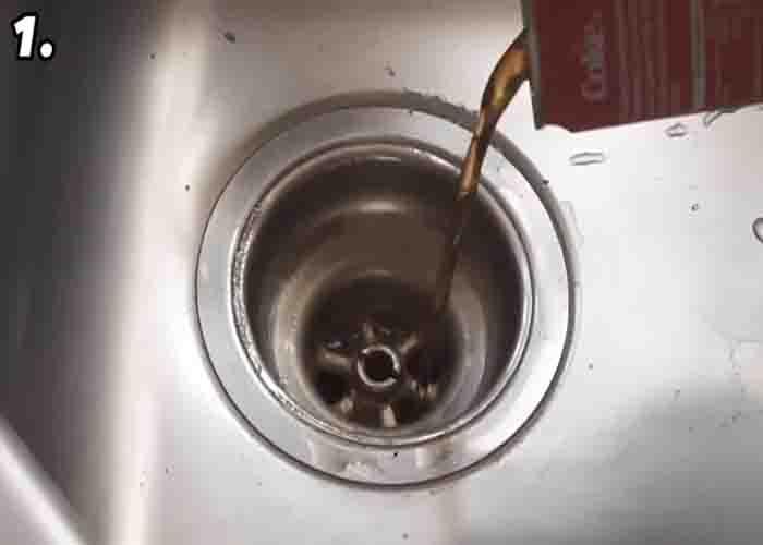 Pouring Coca-Cola down the drain to eliminate bad smells