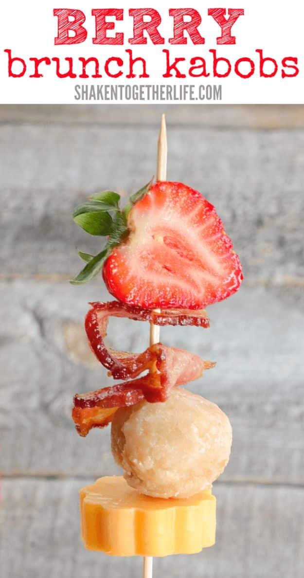 Berry brunch kabobs on skewers with a strawberry, bacon, donut hole and cheese round stacked together
