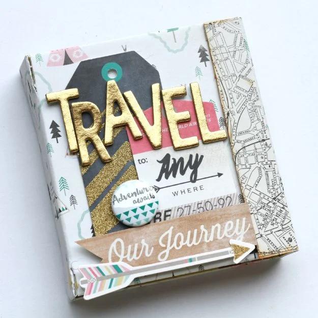 DIY travel photo album with gold TRAVEL letters, a camping print cover and a map print flap down one edge