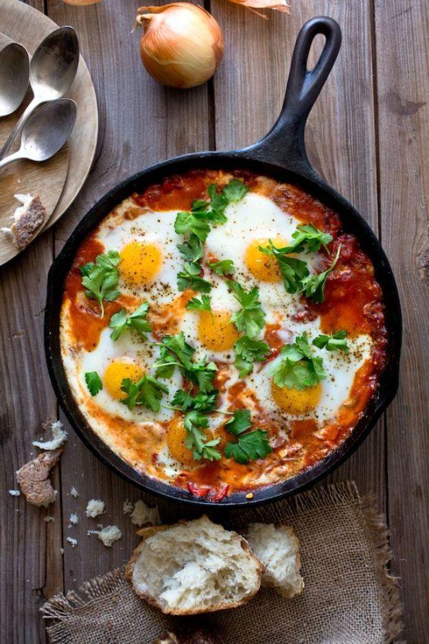 Shakshuka with feta, eggs poached in a spiced tomato and pepper sauce with crumbled feta in a skillet
