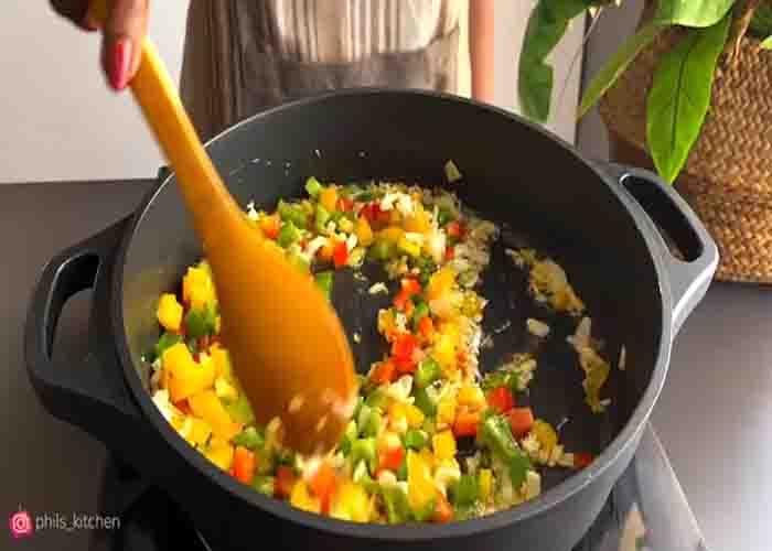 Sauteing the bell peppers for the sausage stew