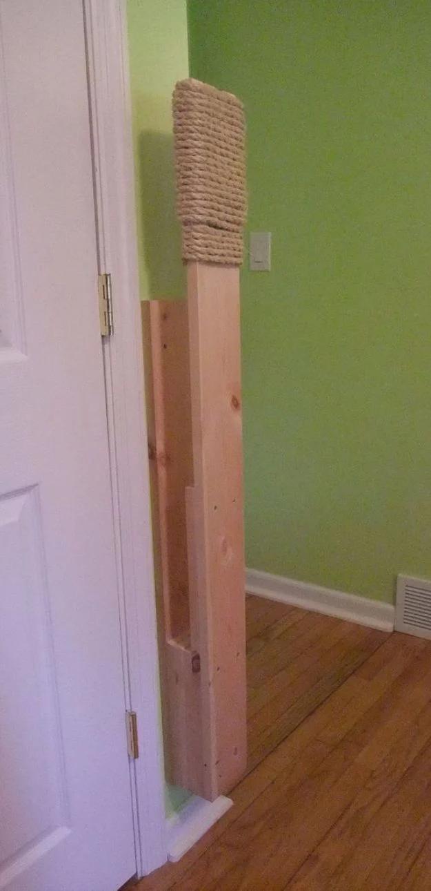 Wall mounted makiwara striking board in a hallway, a pine post with sisal rope wrapped around the top section