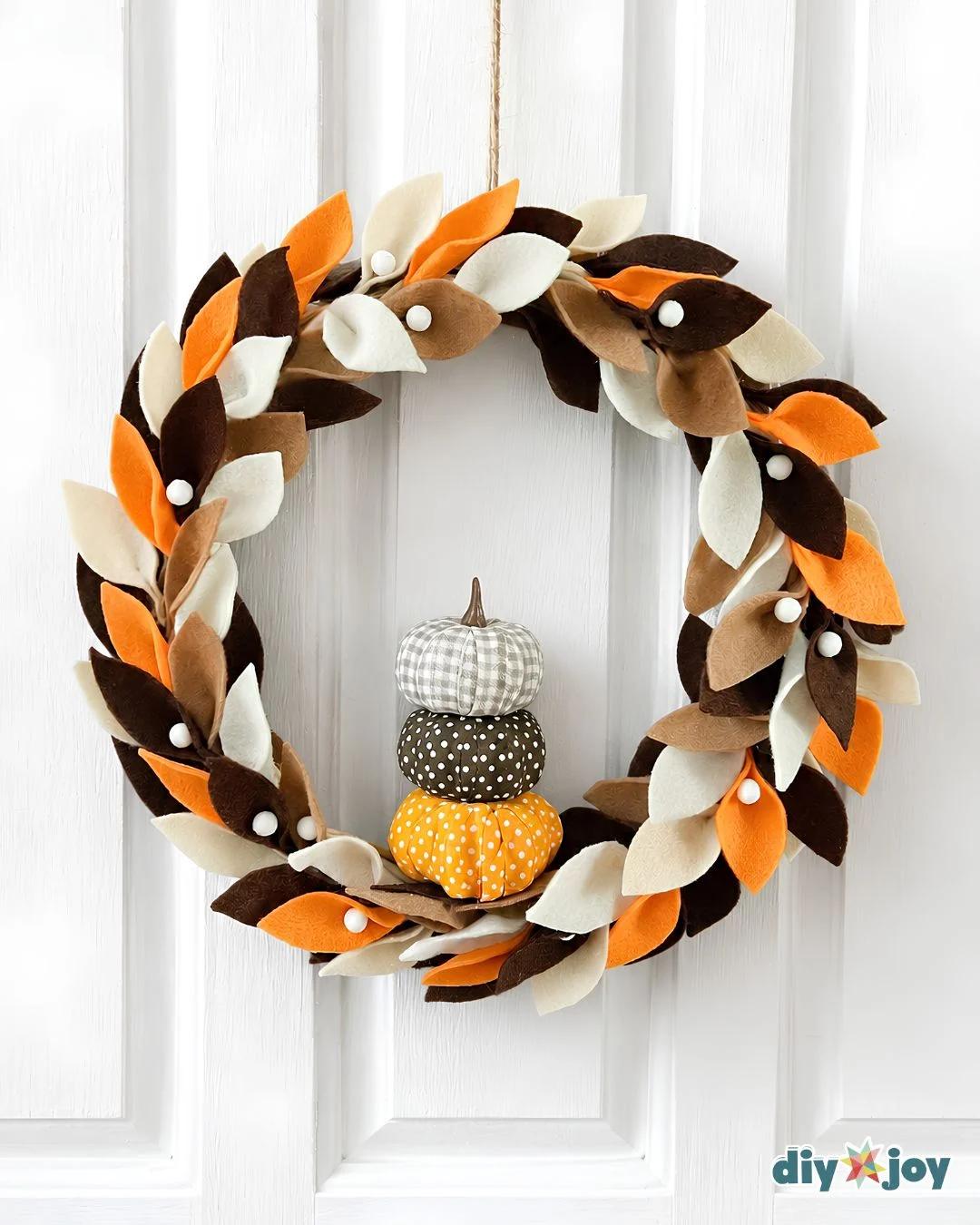 Fall wreaths for front door - finished felt leaf wreath with three stacked fabric pumpkins for cozy autumn decor.