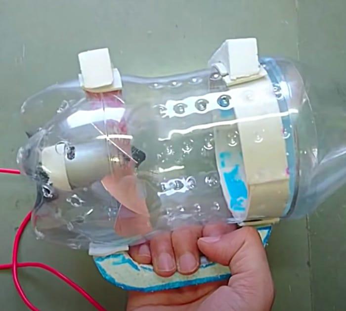Canister vacuum cleaner out of a recycled soda bottle