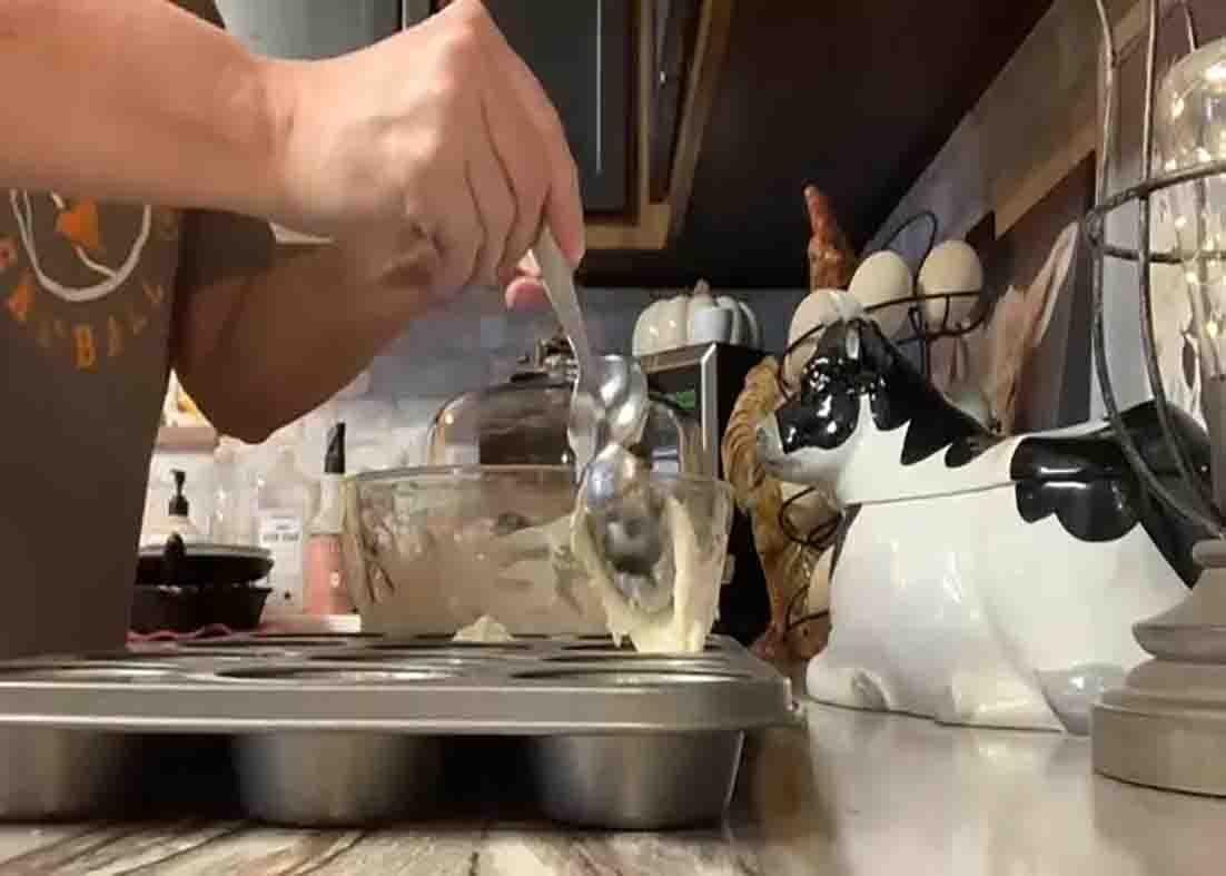 Transferring the mayo rolls batter to the muffin tins