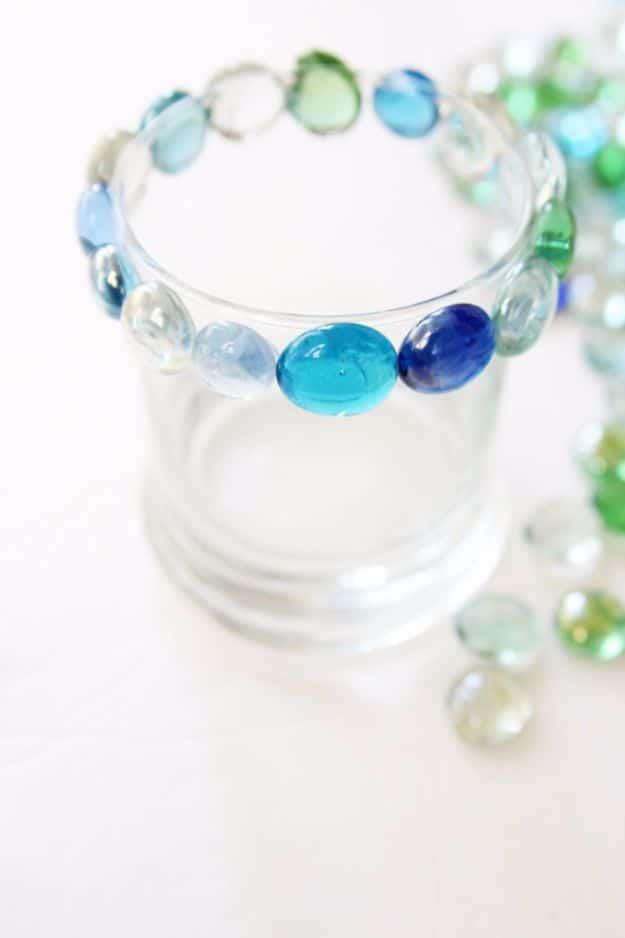 Glass bead mosaic candle holder made from a dollar store find, a budget bead craft that glows with candlelight