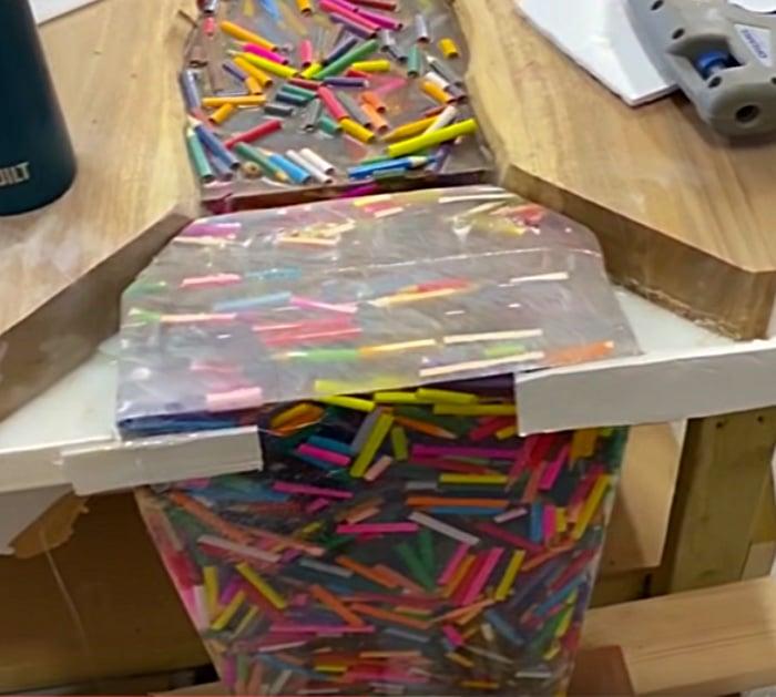 DIY epoxy and wood table with thousands of colored pencils