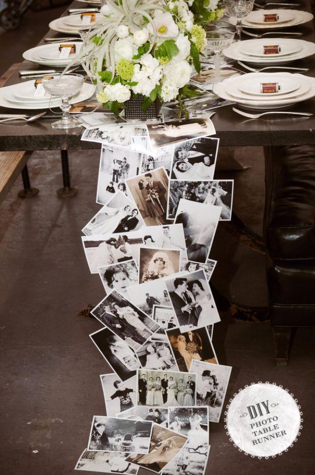 Long table set with white flowers and a cascading runner of overlapping black and white photographs, typeset badge