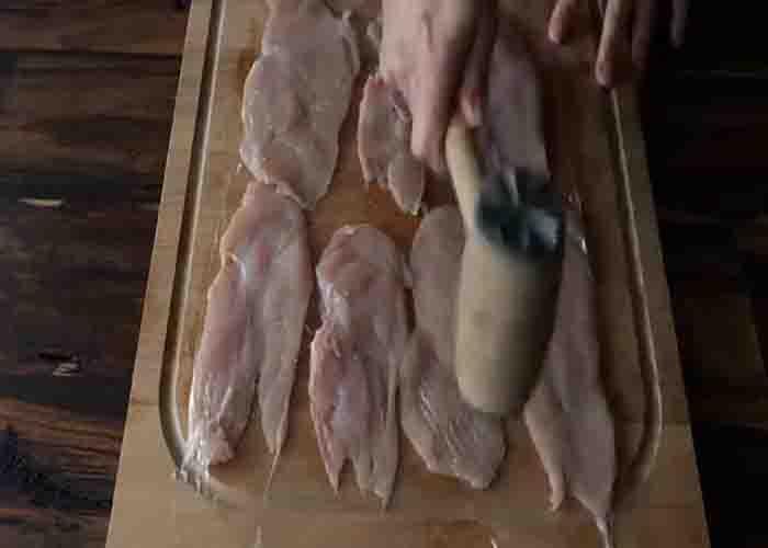 Pounding the chicken breasts flat