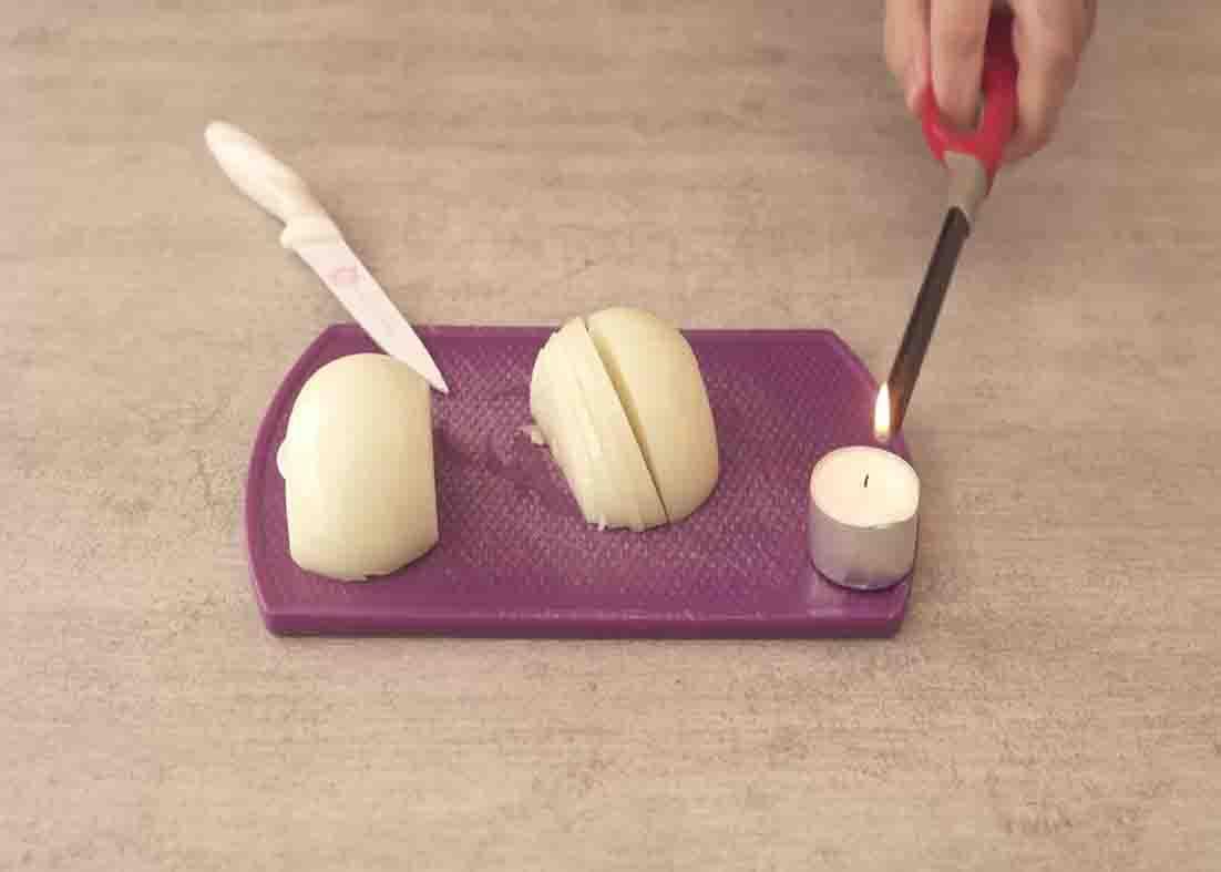 Lighting the candle to prevent eyes from tearing while cutting onions
