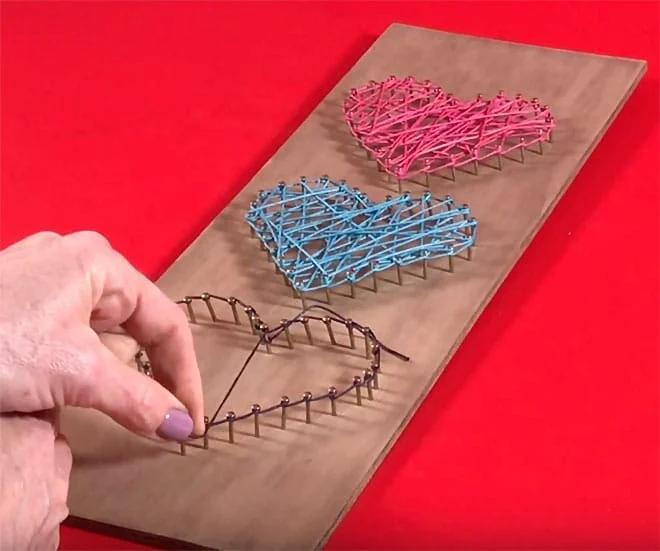 Nail and string art in a simple heart shape, a beginner Etsy shop craft that needs no artistic experience to make