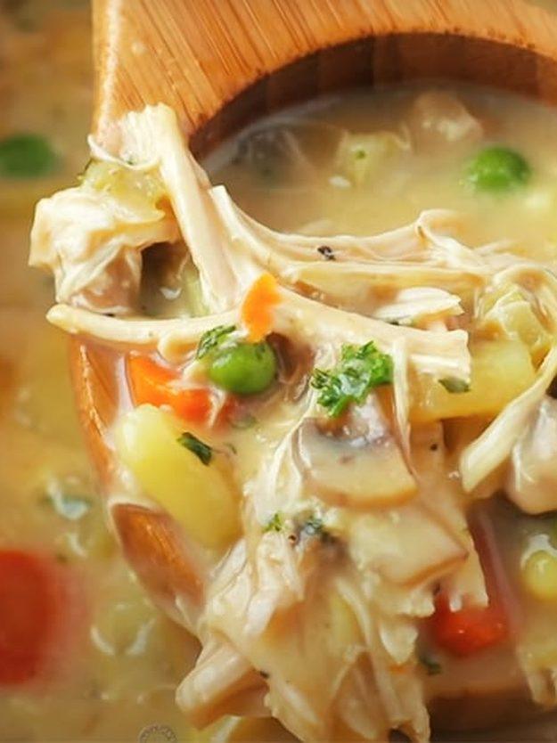 One pot chicken pot pie being ladled from the pot, thick and creamy with shredded chicken, peas and carrot