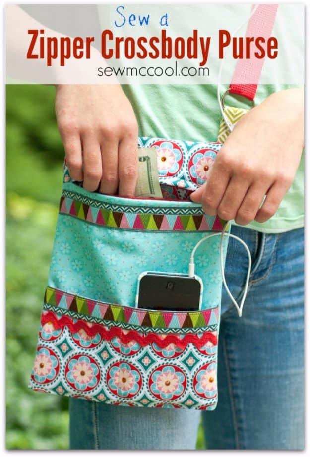 A boho print zippered crossbody purse with a tassel pull hanging from the back of a chair, its lining showing at the top.