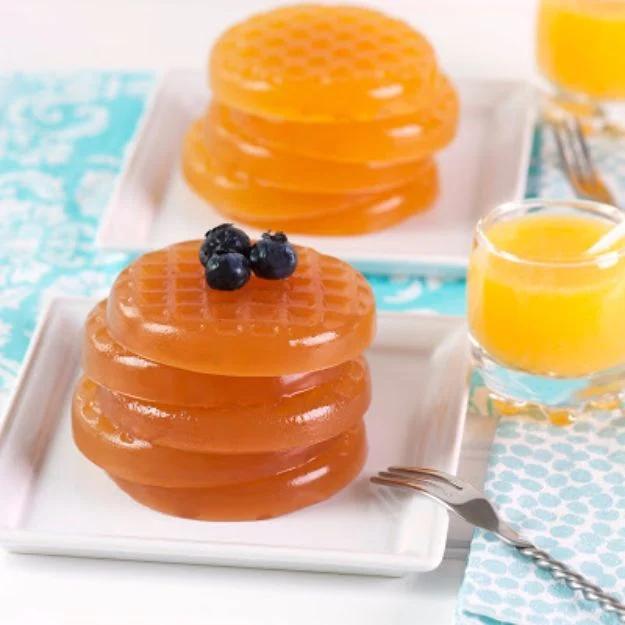 Waffle jello shots, gelatin set in a dimpled ice cream sandwich pan so each shot looks like a small waffle
