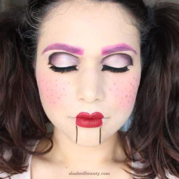 Ventriloquist doll Halloween makeup with pink shadow, painted freckles and straight lines drawn below the lips