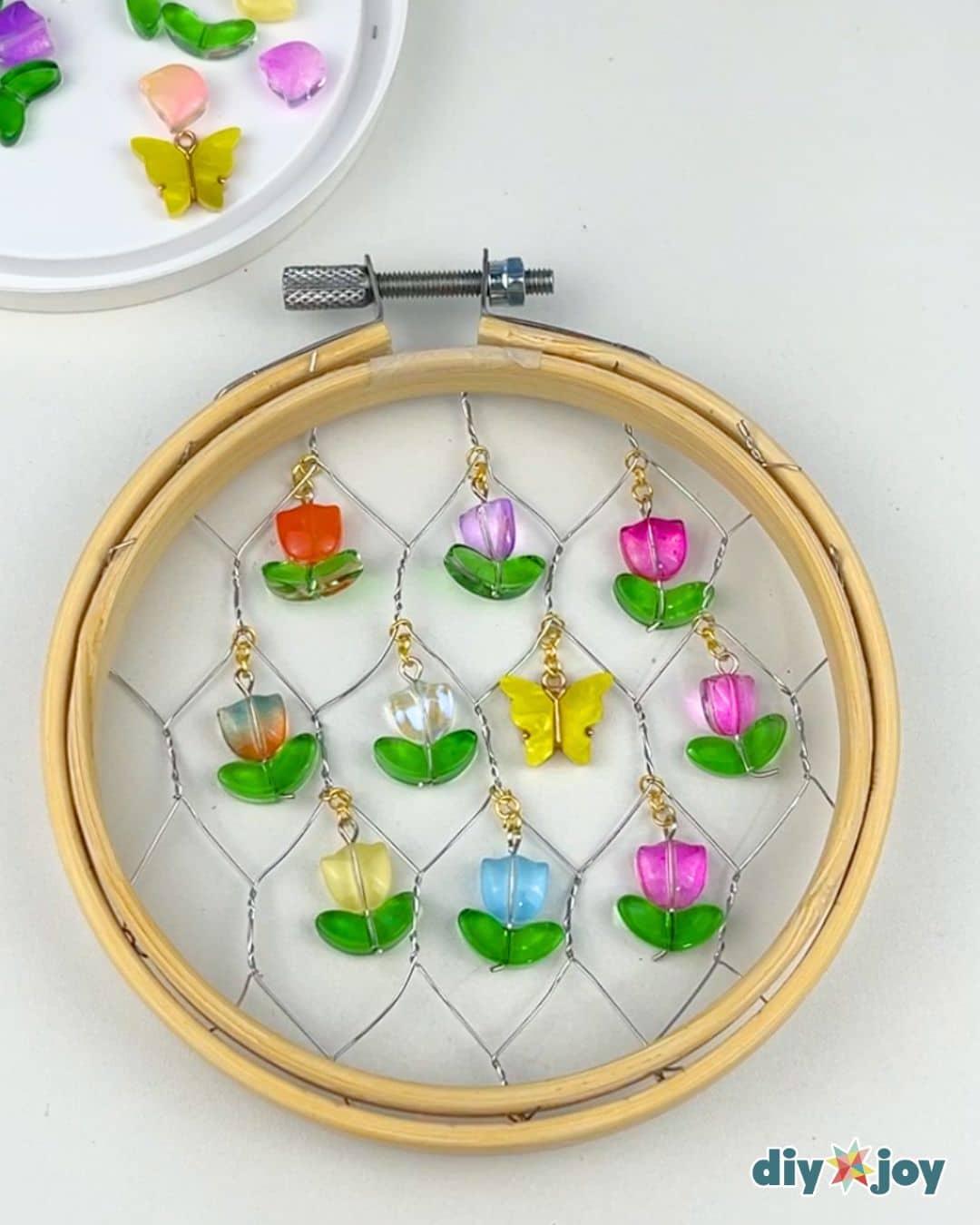 Homemade Chicken Wire Suncatcher — arranging the charms